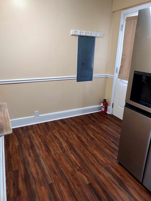 empty room featuring dark hardwood / wood-style flooring and electric panel