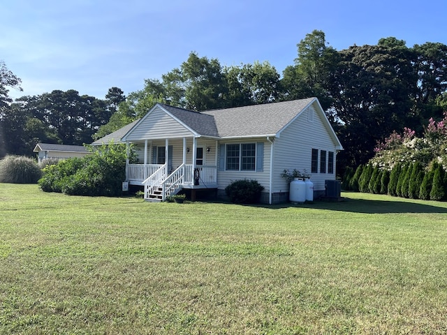 view of front facade featuring a porch, central AC, and a front yard