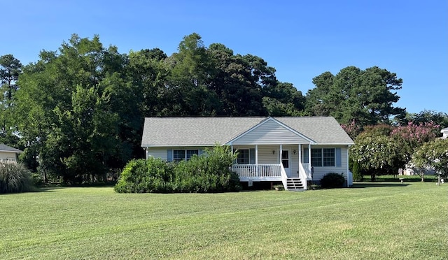 view of front facade with a front yard and covered porch