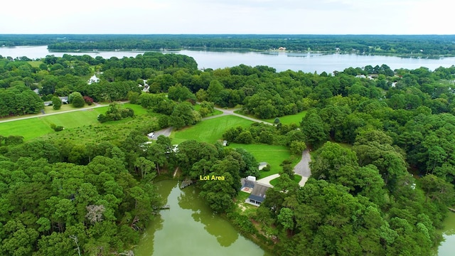 drone / aerial view featuring a water view and a wooded view