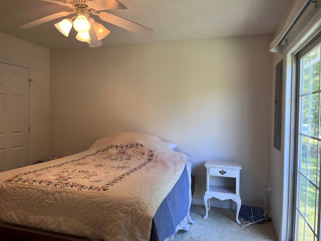 bedroom with a ceiling fan, light carpet, a textured ceiling, and baseboards