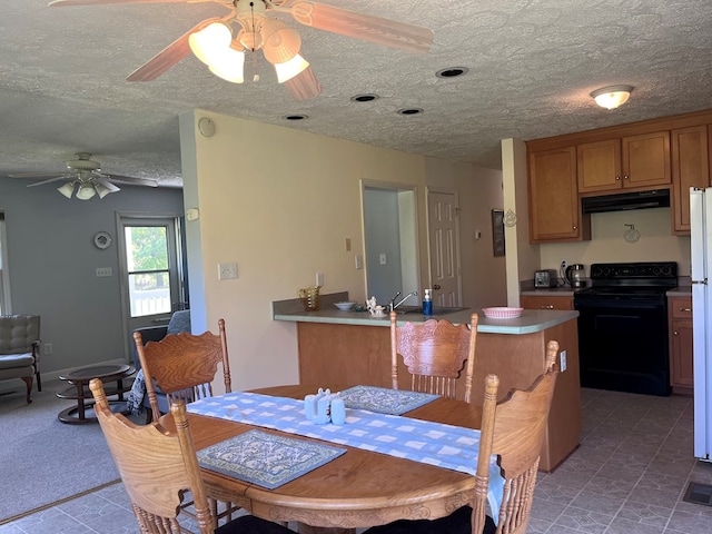 dining space with a textured ceiling and a ceiling fan
