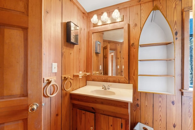 bathroom featuring vanity and wood walls