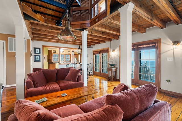 living room with beamed ceiling, light wood-type flooring, french doors, and wooden ceiling