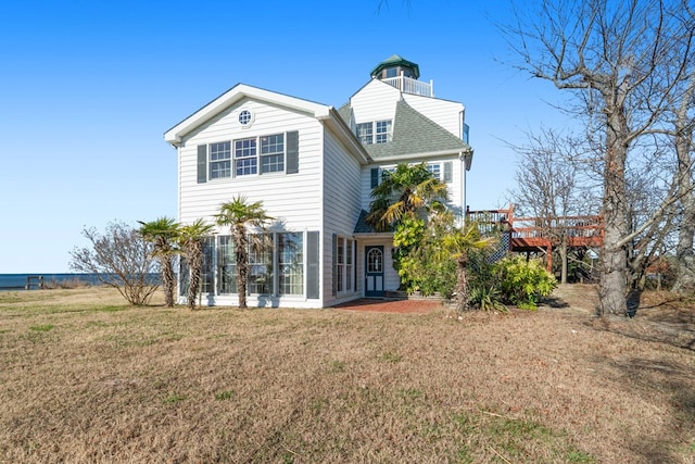 back of house with a sunroom and a yard