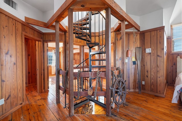 corridor with wood walls and hardwood / wood-style flooring