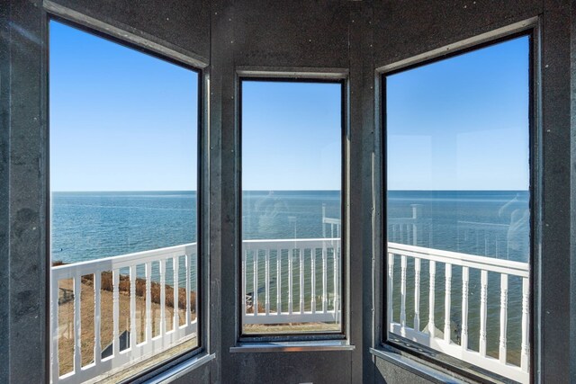 unfurnished sunroom with a water view and a wealth of natural light