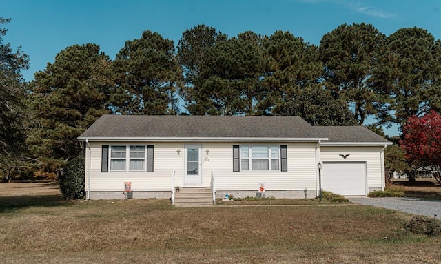 view of front of home with a front yard and a garage