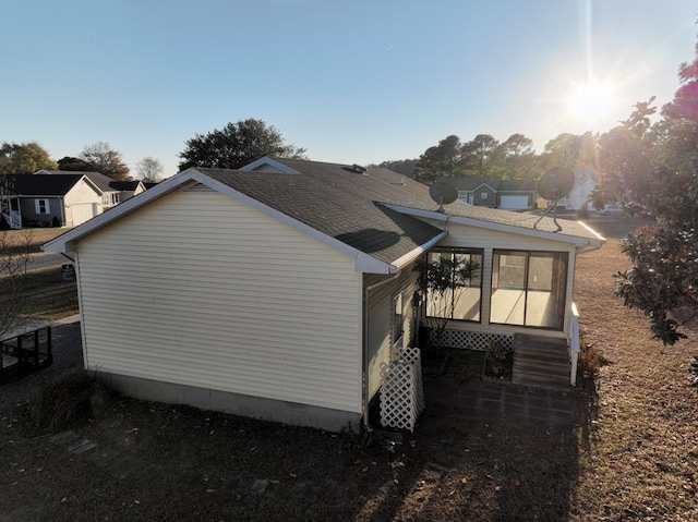 view of home's exterior with a sunroom