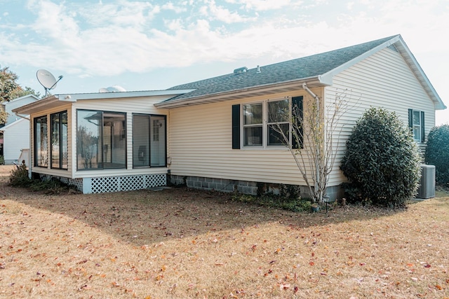 exterior space with central AC, a sunroom, and a front yard