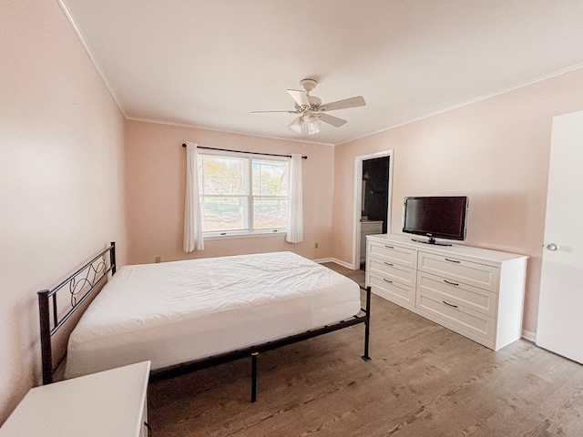 bedroom featuring ceiling fan, light wood-type flooring, and ornamental molding