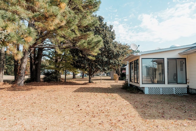 view of yard with a sunroom