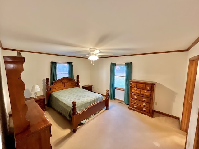 bedroom with ceiling fan, crown molding, and light carpet