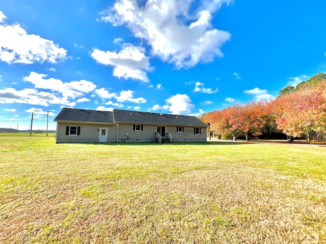 back of house featuring a yard