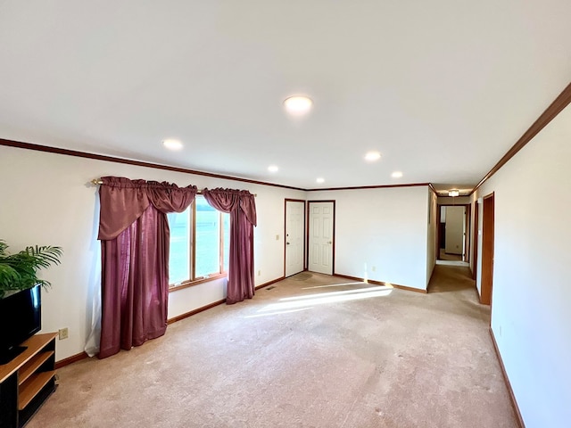 unfurnished living room featuring a water view, crown molding, and light colored carpet