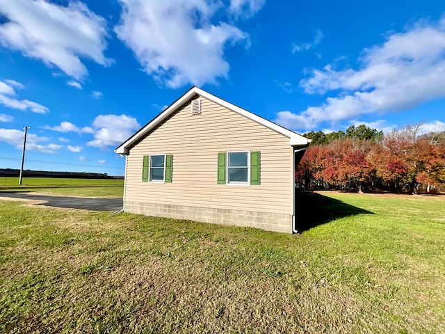 view of home's exterior with a lawn