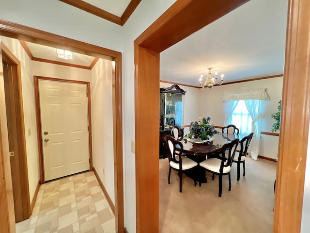 dining area with crown molding and a chandelier