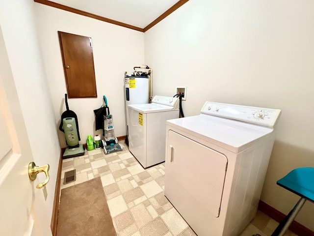 laundry room featuring washing machine and dryer, electric water heater, and crown molding