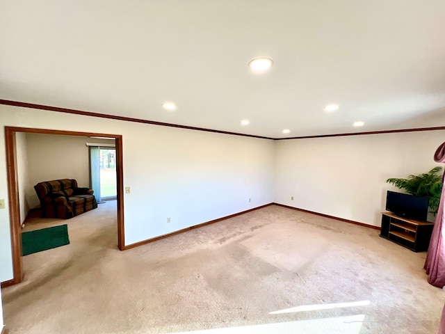 unfurnished living room featuring ornamental molding and light carpet