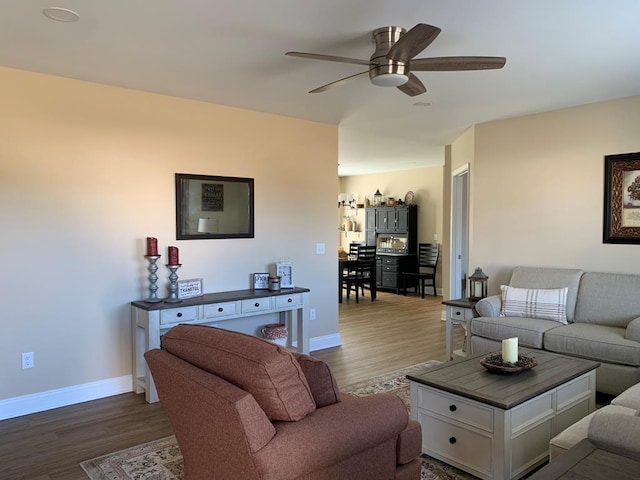 living room featuring hardwood / wood-style flooring and ceiling fan