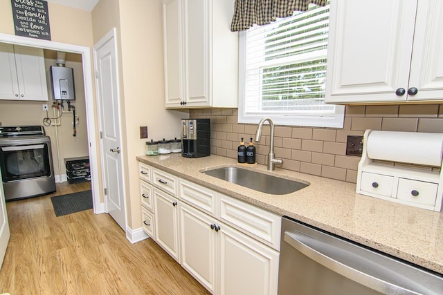 2265 Yardarm Dr, Greenbackville, VA 23356 - kitchen with a sink, light wood-style flooring, water heater, washer / dryer, and stainless steel dishwasher