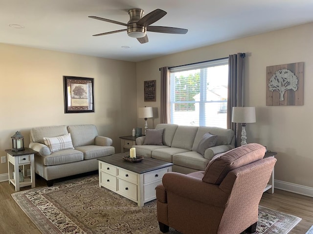 living room featuring dark hardwood / wood-style floors and ceiling fan