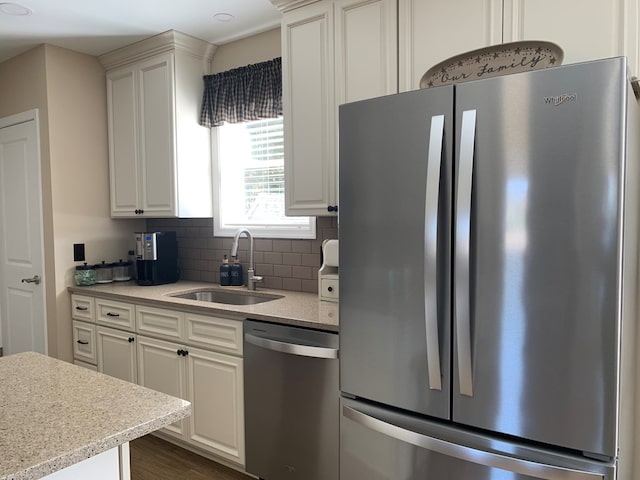 kitchen with backsplash, dark wood-type flooring, sink, white cabinetry, and stainless steel appliances