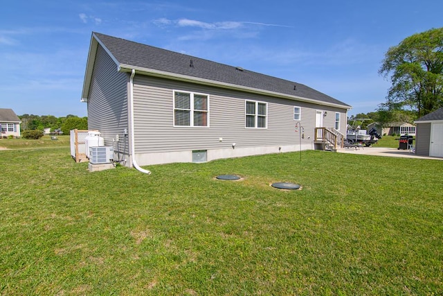 2265 Yardarm Dr, Greenbackville, VA 23356 - rear view of house with a lawn and central air condition unit