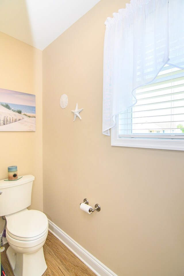2265 Yardarm Dr, Greenbackville, VA 23356 - bathroom featuring baseboards, wood finished floors, and toilet