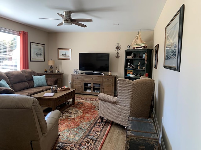 living room with hardwood / wood-style flooring and ceiling fan