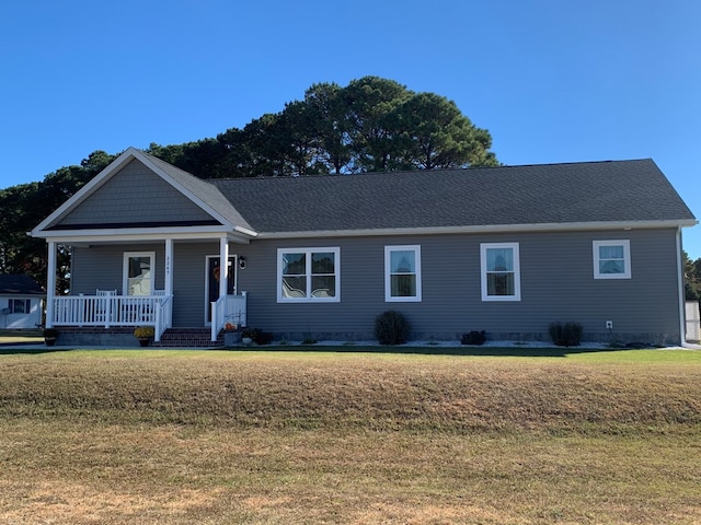 ranch-style home featuring a front yard and covered porch