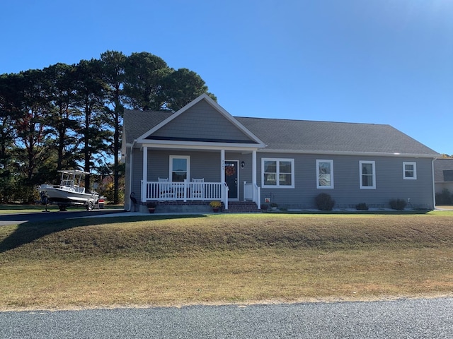 view of front facade with a porch and a front lawn