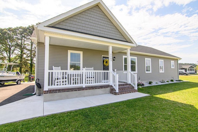 2265 Yardarm Dr, Greenbackville, VA 23356 - view of front of property featuring covered porch and a front lawn