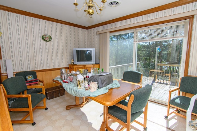 24324 Adams Hill Dr, Accomac, VA 23301 - dining space featuring wainscoting, a chandelier, and ornamental molding
