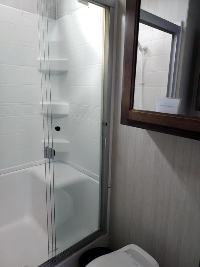 bathroom with toilet and walk in shower