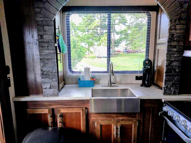 kitchen with electric range, a wealth of natural light, and sink