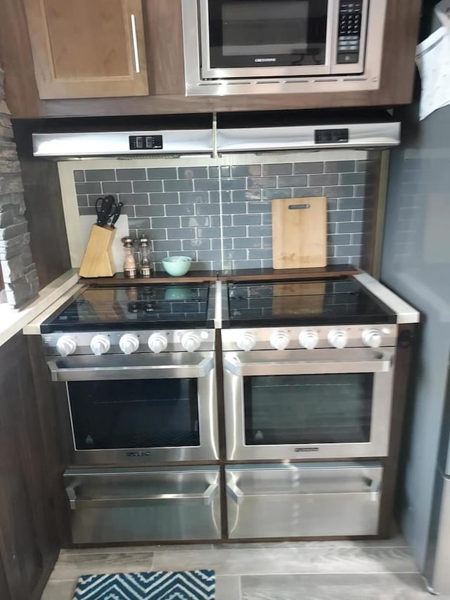 interior details featuring backsplash and stainless steel appliances