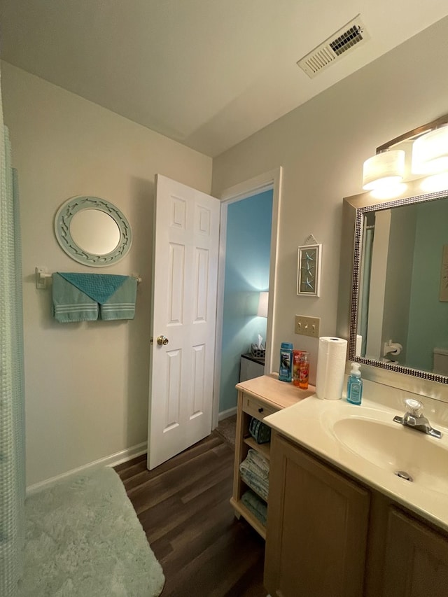 4097 Grand Bay Ct, Chincoteague, VA 23336 - bathroom featuring wood finished floors, vanity, and baseboards