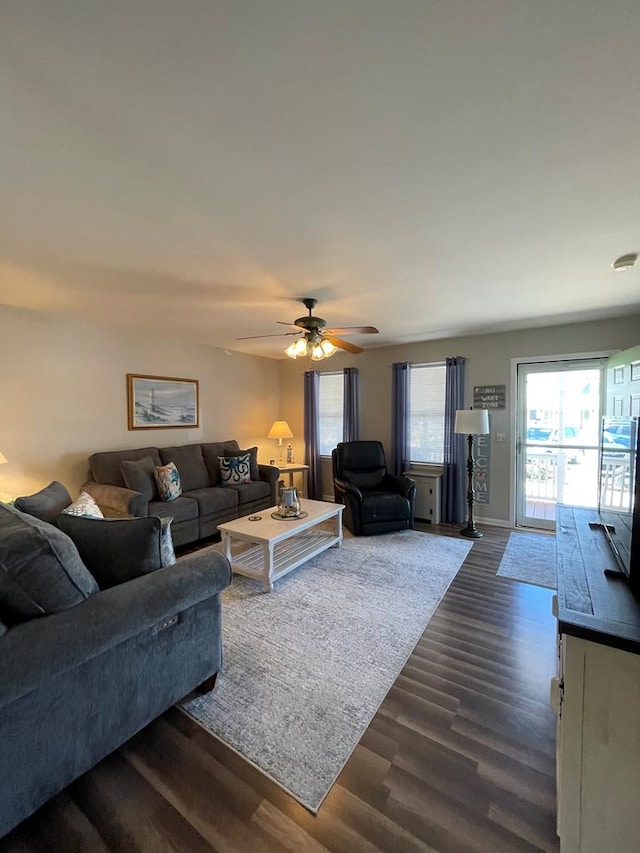 4097 Grand Bay Ct, Chincoteague, VA 23336 - living area featuring dark wood finished floors, a ceiling fan, and baseboards