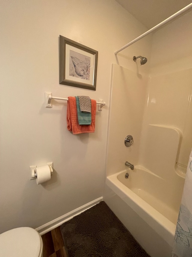 4097 Grand Bay Ct, Chincoteague, VA 23336 - bathroom with baseboards, toilet,  shower combination, and wood finished floors