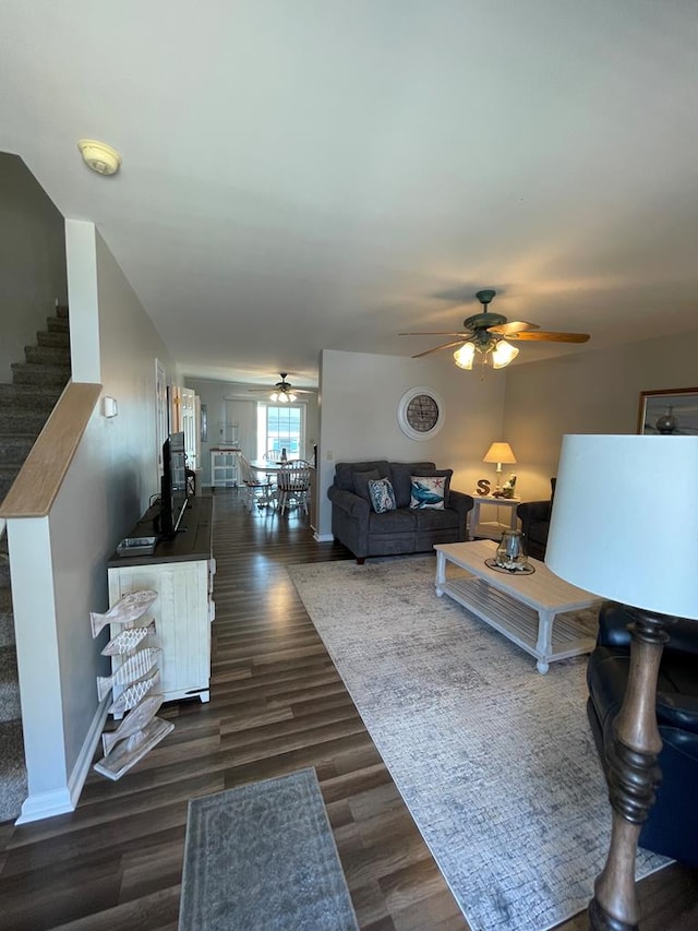 4097 Grand Bay Ct, Chincoteague, VA 23336 - living area with ceiling fan, dark wood-style flooring, baseboards, and stairs