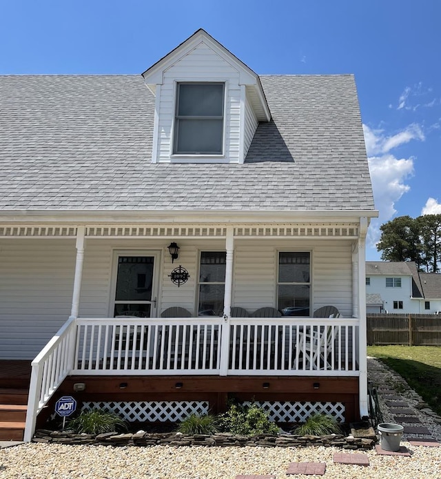4097 Grand Bay Ct, Chincoteague, VA 23336 - view of front of house with covered porch, roof with shingles, and fence