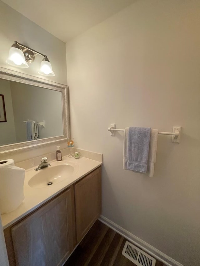 4097 Grand Bay Ct, Chincoteague, VA 23336 - bathroom with wood finished floors, vanity, and baseboards