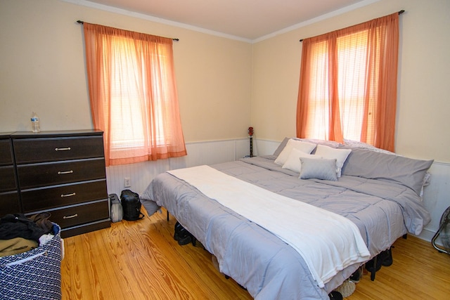 19499 Main St, Melfa, VA 23410 - bedroom with wood finished floors, crown molding, and a wainscoted wall