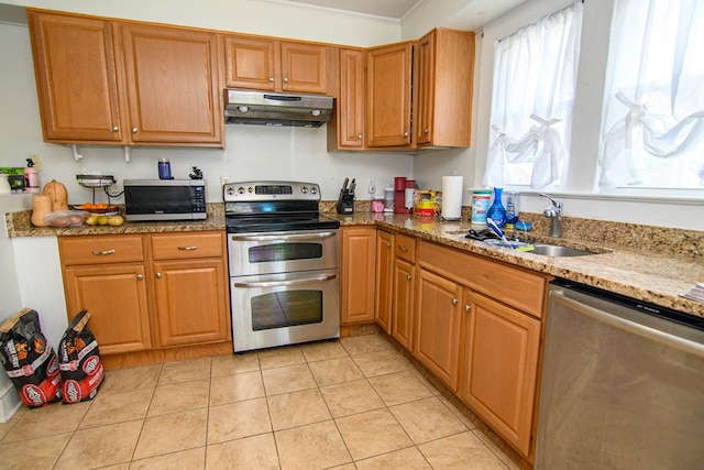 19499 Main St, Melfa, VA 23410 - kitchen featuring under cabinet range hood, stainless steel appliances, light stone countertops, ornamental molding, and light tile patterned floors