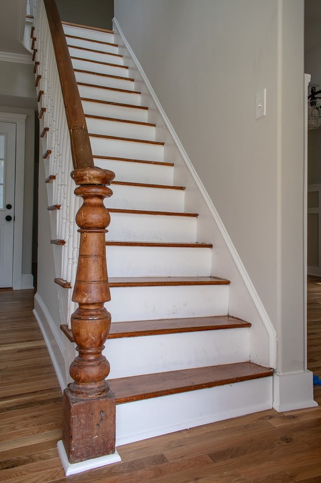 stairs with baseboards and wood finished floors