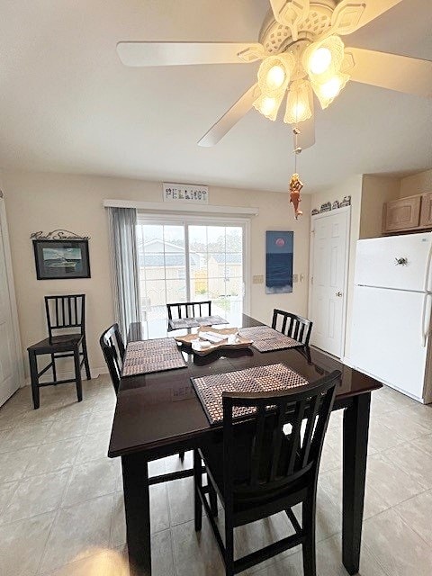 dining room with a ceiling fan and light tile patterned flooring