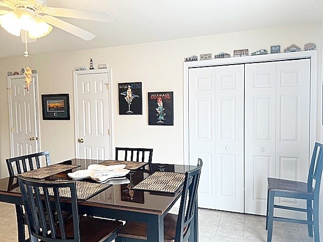 dining space with light tile patterned floors and a ceiling fan