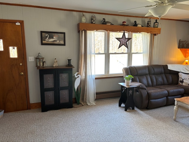 living room with ornamental molding, carpet floors, ceiling fan, and baseboard heating