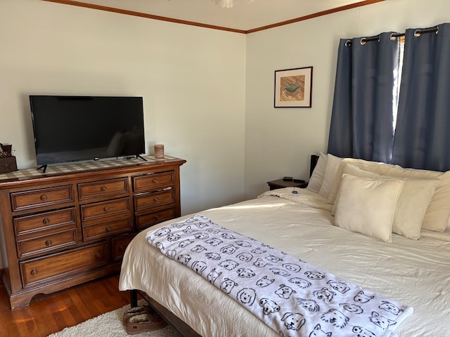 bedroom featuring hardwood / wood-style floors and crown molding